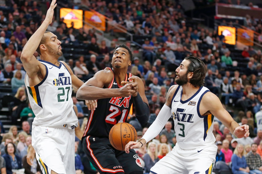 Miami Heat center Hassan Whiteside (21) loses the ball as Utah Jazz's Rudy Gobert (27) and Ricky Rubio (3) defend in the first half during an NBA basketball game Friday, Nov. 10, 2017, in Salt Lake City. (AP Photo/Rick Bowmer)