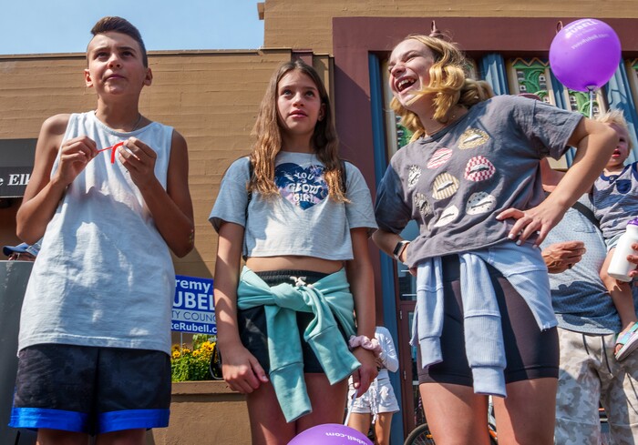 (Leah Hogsten | The Salt Lake Tribune) l-r Zander Mettle, 11, his sister Aria,9, and their friend Tayci Breen, 13, laugh as the parade moves down Main Street in Park City on Labor Day, Sept. 6, 2021 during its 125th anniversary celebration of MinersÕ Day.