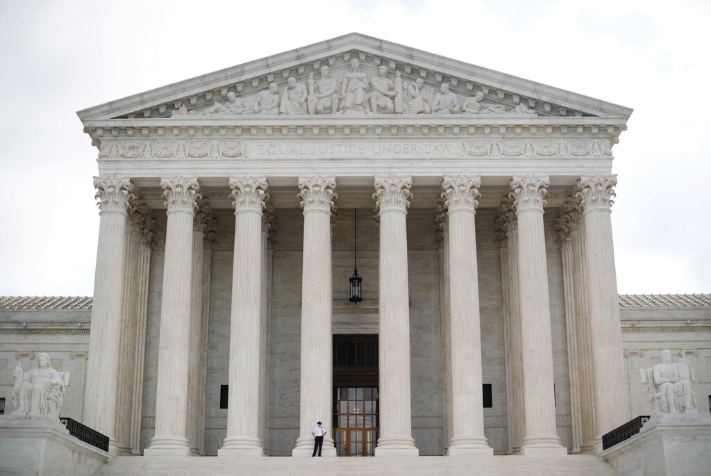(Pablo Martinez Monsivais | AP Photo) In this Oct. 9, 2018 photo, police office guards the main entrance to the Supreme Court in Washington. The Supreme Court is taking up its first gun rights case in nine years, a challenge to New York City's prohibition on carrying a licensed, locked and unloaded handgun outside the city limits. The court's decision Tuesday to take on the appeal filed by three New York residents and New York's National Rifle Association affiliate could signal a revived interest in gun rights by a more conservative court. The case won't be argued until October.