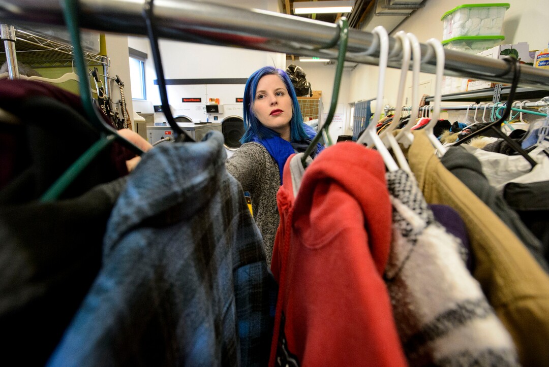 (Steve Griffin  |  The Salt Lake Tribune)  Natalie Bagnell, a volunteer at Volunteers of America, sorts clothing that has been donated to help homeless young people in Salt Lake City Monday December 11, 2017.