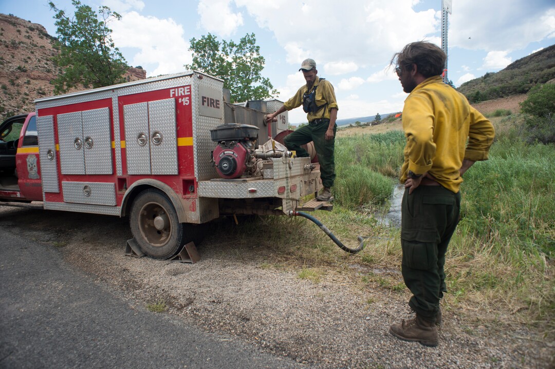 (Rick Egan  |  The Salt Lake Tribune)       The Playing Buffalo firefighters from Boise, ID,  fill up their truck as they work on the hotspots of the Dollar Ridge Fire near Fruitland. Tuesday, July 10, 2018.