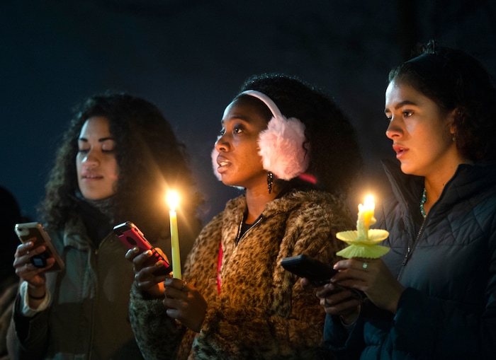 (Rick Egan  |  The Salt Lake Tribune)      Losa Smith, Jodian Grant, Joanna Hildreth-Castrejon sing with the BYU Women of Color club, during a candlelight vigil on BYU campus, for the student who died by suicide this week, at the Tanner Building, Friday, Dec. 7, 2018.