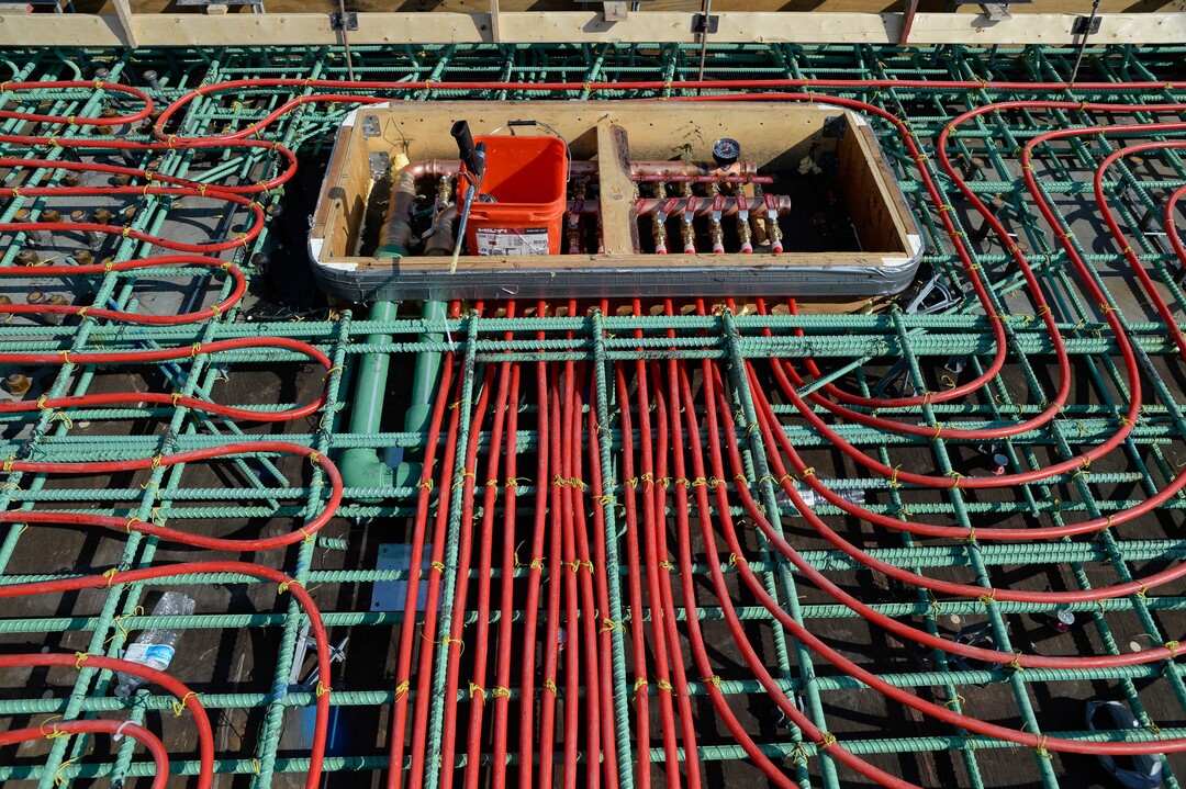 (Francisco Kjolseth  |  The Salt Lake Tribune) UDOT gives a tour of the state’s new longest pedestrian bridge on Thursday, August 20, 2020, connecting Utah Valley University in Orem to student housing and the community on the West side of I-15. Crews are finishing up an extensive hydronic heating system that will pump warm water to keep the bridge clear of snow in the winters, as it gets ready to pour concrete for the walking surface. UDOT will close I-15 in both directions this weekend for work on the nearly 1,000 foot bridge that is 15 feet wide to accommodate pedestrians, cyclists and scooters. Elevators and stairs with small ramps to push up bicycles will be on each side of the bridge.