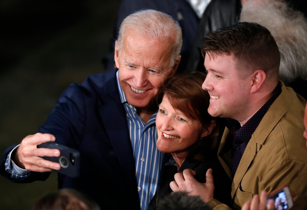 Former Vice President and Democratic presidential candidate Joe Biden poses for photos with audience members during a rally, Wednesday, May 1, 2019, in Des Moines, Iowa. (AP Photo/Charlie Neibergall)