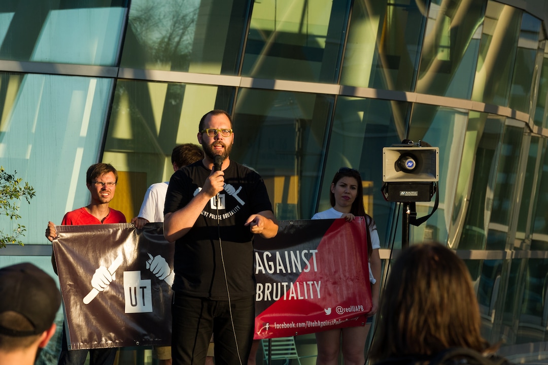 (Alex Gallivan | Special to the Tribune) David Newlin leads the crowd in chants at an Emergency Rally hosted by Utah Against Police Brutality, in response to the arrest of U of U nurse Alex Wubbels. Wubbels was arrested by SLCPD Detective Jeff Payne after she refused to take blood from an unconscious patient, which is against hospital policy.
