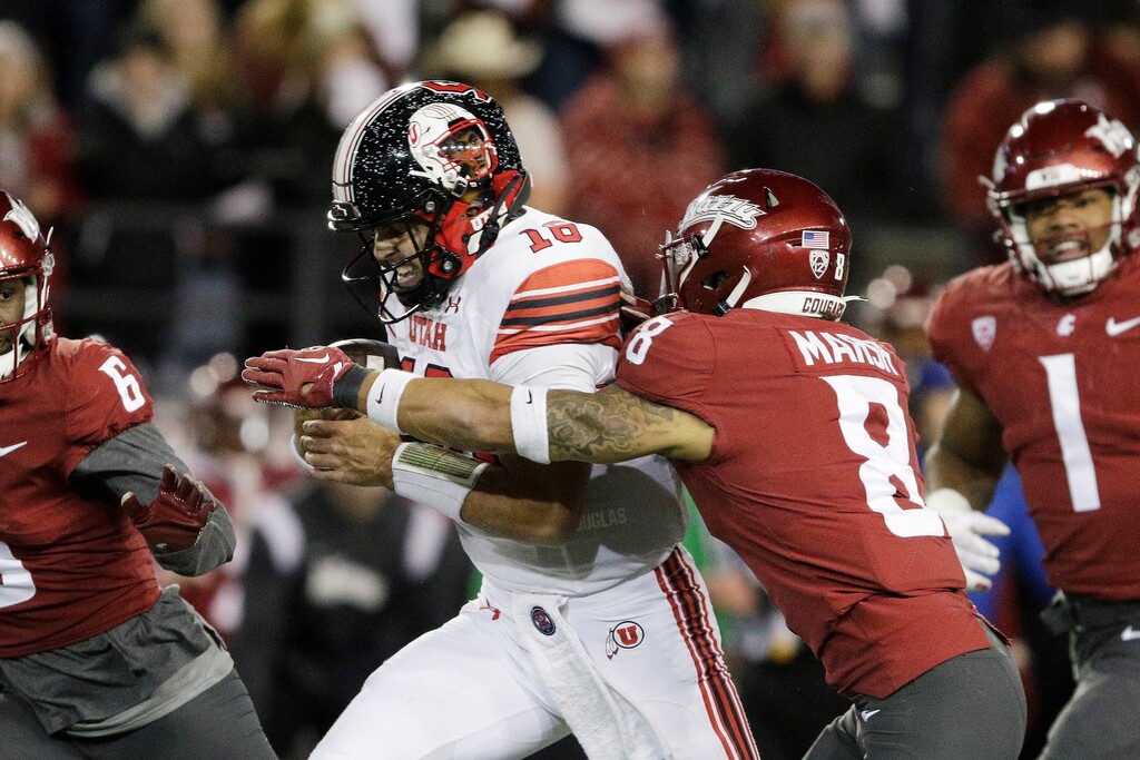 (Young Kwak | AP) Utah quarterback Bryson Barnes (16) tries to get away from Washington State defensive back Armani Marsh (8) during the second half of an NCAA college football game, Thursday, Oct. 27, 2022, in Pullman, Wash.