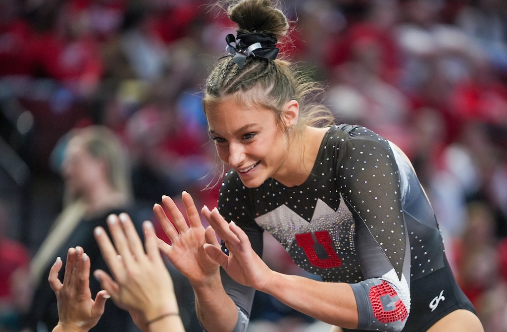(Chris Samuels | The Salt Lake Tribune) Utah’s Grace McCallum greets teammates after competing on floor during a college gymnastics meet.