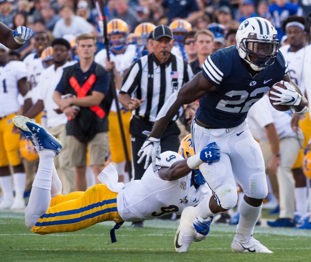 (Rick Egan  |  The Salt Lake Tribune)    Brigham Young Cougars running back Squally Canada (22) gets past McNeese State Cowboys defensive lineman Cody Roscoe (57) and McNeese State Cowboys defensive back Trent Jackson (9), in football action Brigham Young Cougars vs McNeese State Cowboys at Lavell Edwards Stadium, Saturday, Sept. 22, 2018.