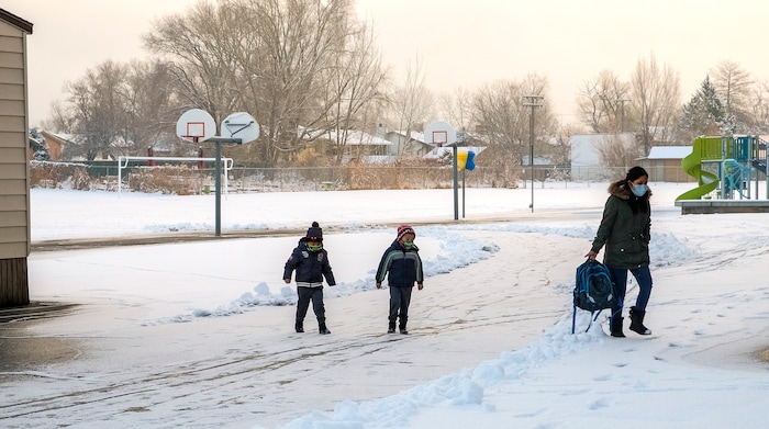 (Leah Hogsten | The Salt Lake Tribune) A parent walks her Escalante Elementary students back to class in Salt Lake City head back to class, January, 25, 2021. Salt Lake City School District reopened all of the district's elementary schools to in-person learning on Monday. It is the first time students in kindergarten through sixth grade are back in the classroom for a full day of school since they first closed for the pandemic in March 2020.