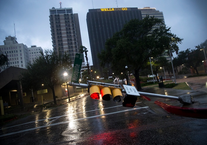 (Nick Wagner | Austin American-Statesman via AP) A damaged stop light blocks a street as Hurricane Harvey makes landfall in Corpus Christi, Texas, on Friday, Aug. 25, 2017. Hurricane Harvey smashed into Texas late Friday, lashing a wide swath of the Gulf Coast with strong winds and torrential rain from the fiercest hurricane to hit the U.S. in more than a decade.