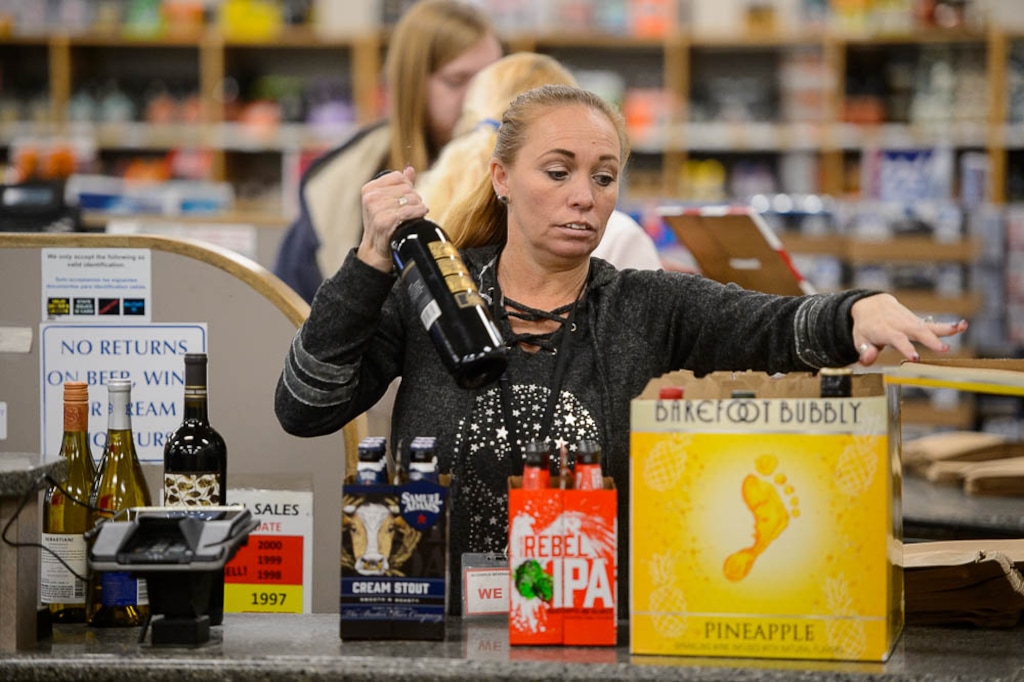 (Trent Nelson | The Salt Lake Tribune)  
Tracy Logsdon working at the liquor store in Sandy on Tuesday Nov. 20, 2018.