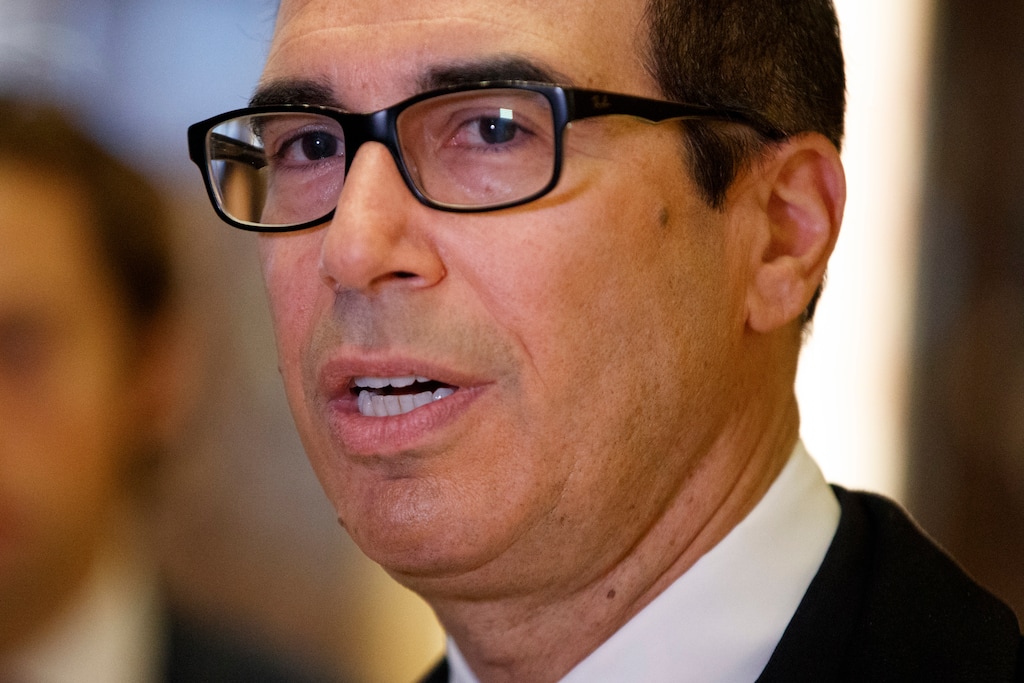 FILE - In this Nov. 30, 2016 file photo, Steven Mnuchin talks with reporters in the lobby of Trump Tower in New York. Sears said Friday, Dec. 2 that Steven Mnuchin has stepped down from the department store’s board, a week after President-elect Donald Trump nominated Mnuchin to be the country’s Treasury secretary. Mnuchin has been on the Sears Holdings Corp. board for more than 11 years, the company said. (AP Photo/Evan Vucci)