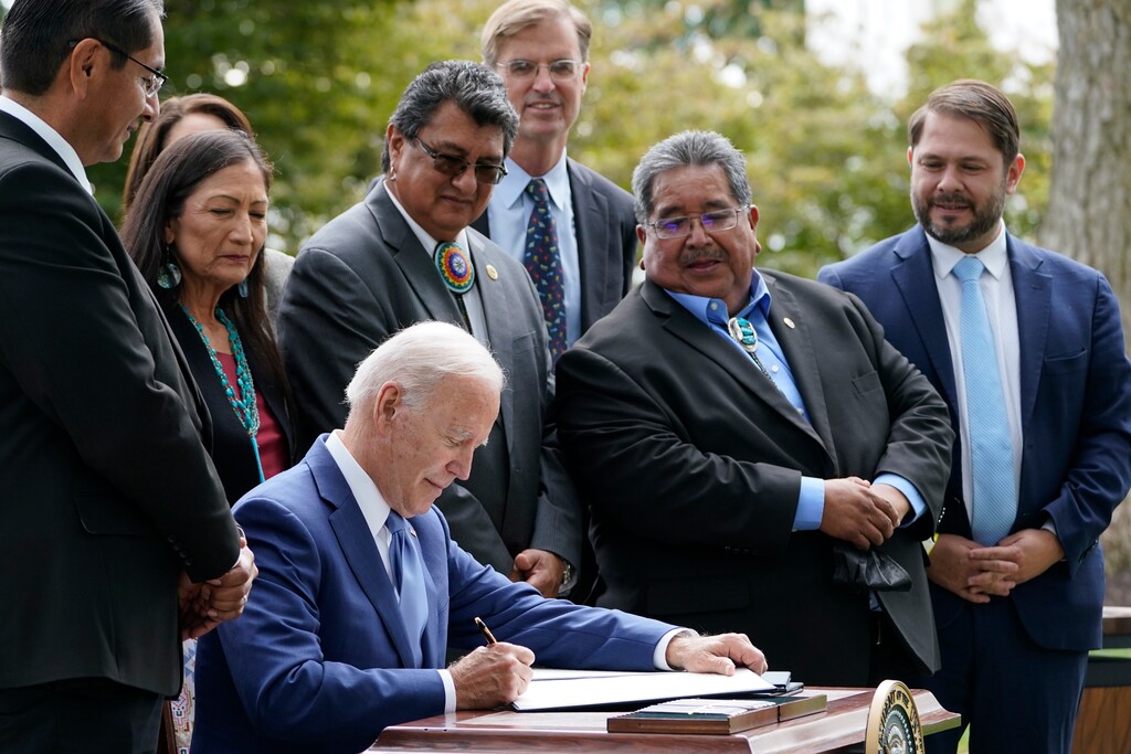 (Susan Walsh | AP) President Joe Biden signs proclamations on the North Lawn at the White House in Washington, Friday, Oct. 8, 2021, during an event announcing that his administration is restoring protections for two sprawling national monuments in Utah that have been at the center of a long-running public lands dispute, and a separate marine conservation area in New England that recently has been used for commercial fishing.