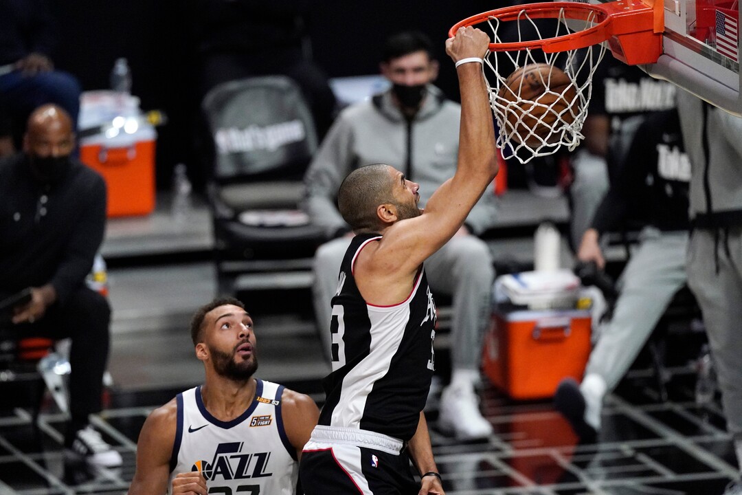 Los Angeles Clippers forward Nicolas Batum, right, dunks as Utah Jazz center Rudy Gobert watches during the second half of Game 3 of a second-round NBA basketball playoff series Saturday, June 12, 2021, in Los Angeles. (AP Photo/Mark J. Terrill)