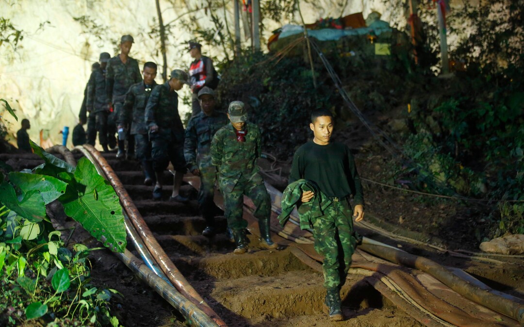 Rescuers make their way down at the entrance to a cave complex where 12 boys and their soccer coach went missing, in Mae Sai, Chiang Rai province, in northern Thailand, Monday, July 2, 2018. Rescue divers are advancing in the main passageway inside the flooded cave in northern Thailand where the boys and their coach have been missing more than a week. (AP Photo/Sakchai Lalit)