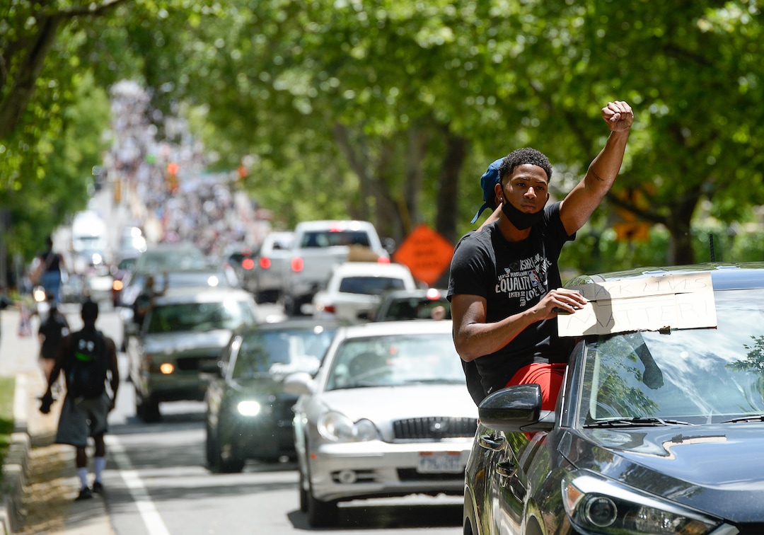 (Francisco Kjolseth  |  The Salt Lake Tribune) Hundreds march in downtown Salt Lake City and wave signs from cars on Saturday, May 30, 2020, to protest the death of George Floyd, the man who died at the hands of Minneapolis police officer. Derek Michael Chauvin, the police officer who kneeled on his neck,  was later convicted of murder.