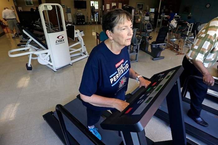 In this Aug. 15, 2017, photo, Rita Driscoll works on a treadmill in a supervised exercise therapy program for patients with peripheral artery disease at University of Minnesota Medical Center in Minneapolis. Medicare soon will start paying hospitals and clinics for these exercise sessions, making the therapy available for thousands of older Americans with a specific type of leg pain. (AP Photo/Jim Mone)