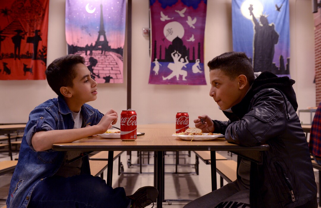 (Leah Hogsten  |  The Salt Lake Tribune) l-r Iraqi refugees Ali Al Sarag and his friend and Granite Park Junior High student Sajjad Alsheri enjoy dinner at the school. Sixteen members of Granite Park Junior High SchoolÕs faculty prepared and served a hot spaghetti meal to students and their families, Friday, December 22, 2017 at the school for the inaugural ÔDinner at the Park.' Roughly 90 percent of students who attend Granite Park Junior High in South Salt Lake qualify for free or reduced lunch through the federal school lunch program. Knowing the challenges faced by their students, staff members at Granite Park came up with an idea to help families through the holidays.