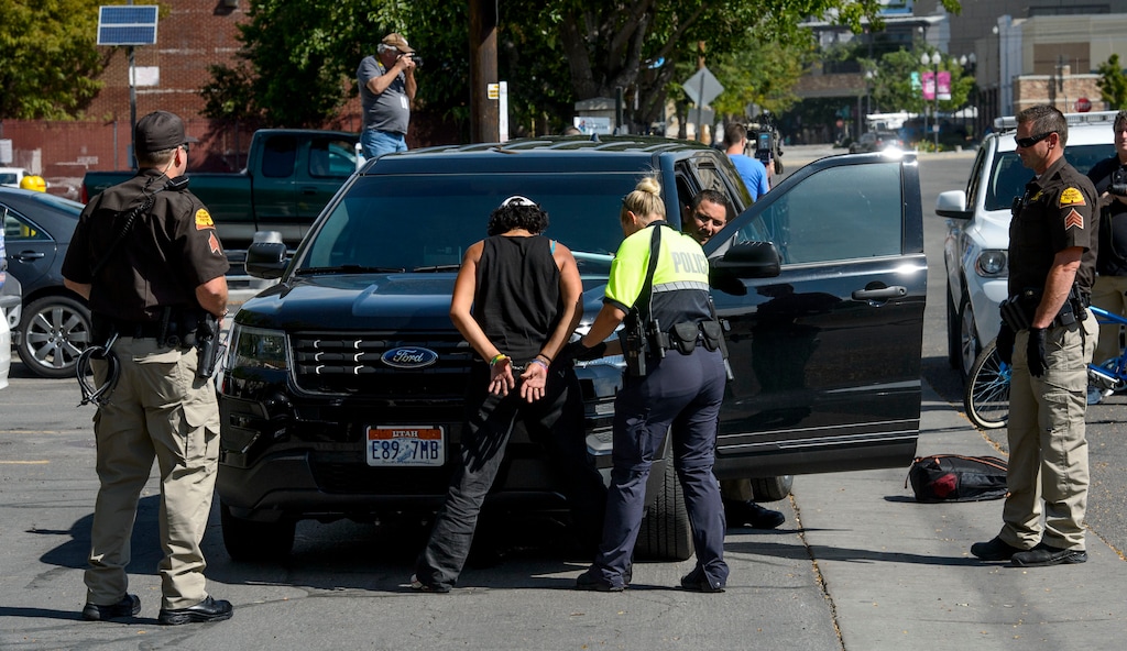 (Steve Griffin  |  The Salt Lake Tribune)  UHP Troopers make an arrest on 400 west as law enforcement officers from several agencies increase their presence in the Rio Grand homeless area in Salt Lake City Monday August 14, 2017.