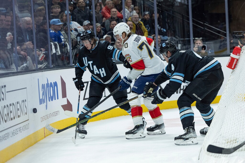 Utah Hockey Club center Logan Cooley (92) and defenseman Juuso Valimaki (4) fight for the puck against Florida Panthers center Jesper Boqvist (70) during the second period of an NHL hockey game, Wednesday, Jan. 8, 2025, in Salt Lake City. (AP Photo/Melissa Majchrzak)