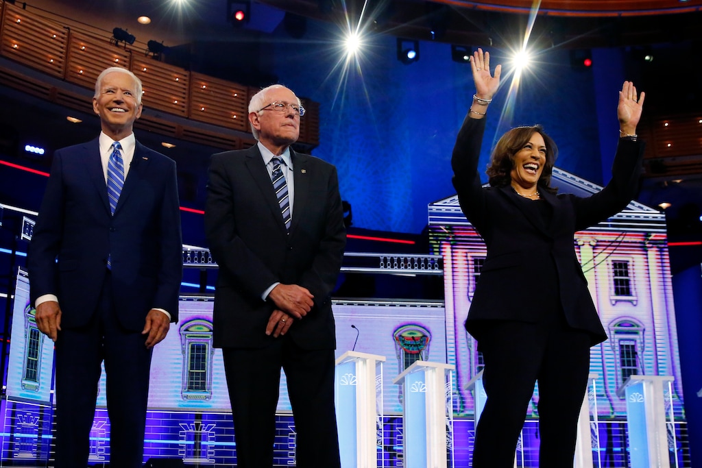 Democratic presidential candidates former vice president Joe Biden, left, Sen. Bernie Sanders, I-Vt., and Sen. Kamala Harris, D-Calif., right, stand on stage for a photo op before the start of the the Democratic primary debate hosted by NBC News at the Adrienne Arsht Center for the Performing Arts, Wednesday, June 27, 2019, in Miami. (AP Photo/Wilfredo Lee)