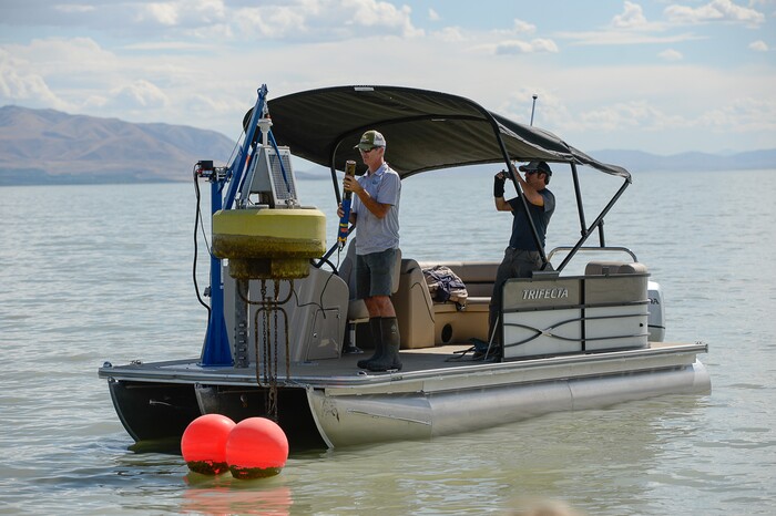 (Francisco Kjolseth | The Salt Lake Tribune) Marshall Baillie, center, with the division of water quality attends one of three Dip Test sensors in Utah Lake used for collecting data on. Members of the Legislative Water Development Commission take a tour of Utah Lake on Wednesday, Sept. 13, 2017, for the purpose of learning of wastewater treatment, the importance of protecting our lakes and rivers, how the state is looking to change water quality standards and how regulation is an important local issue.