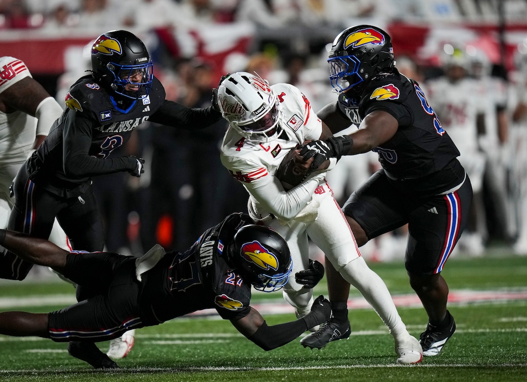 (Bethany Baker  |  The Salt Lake Tribune) Kansas Jayhawks tackle Utah Utes quarterback Devon Dampier (4) during the game between the Utah Utes and the Kansas Jayhawks at Rice-Eccles Stadium in Salt Lake City on Saturday, Oct. 10, 2026.
