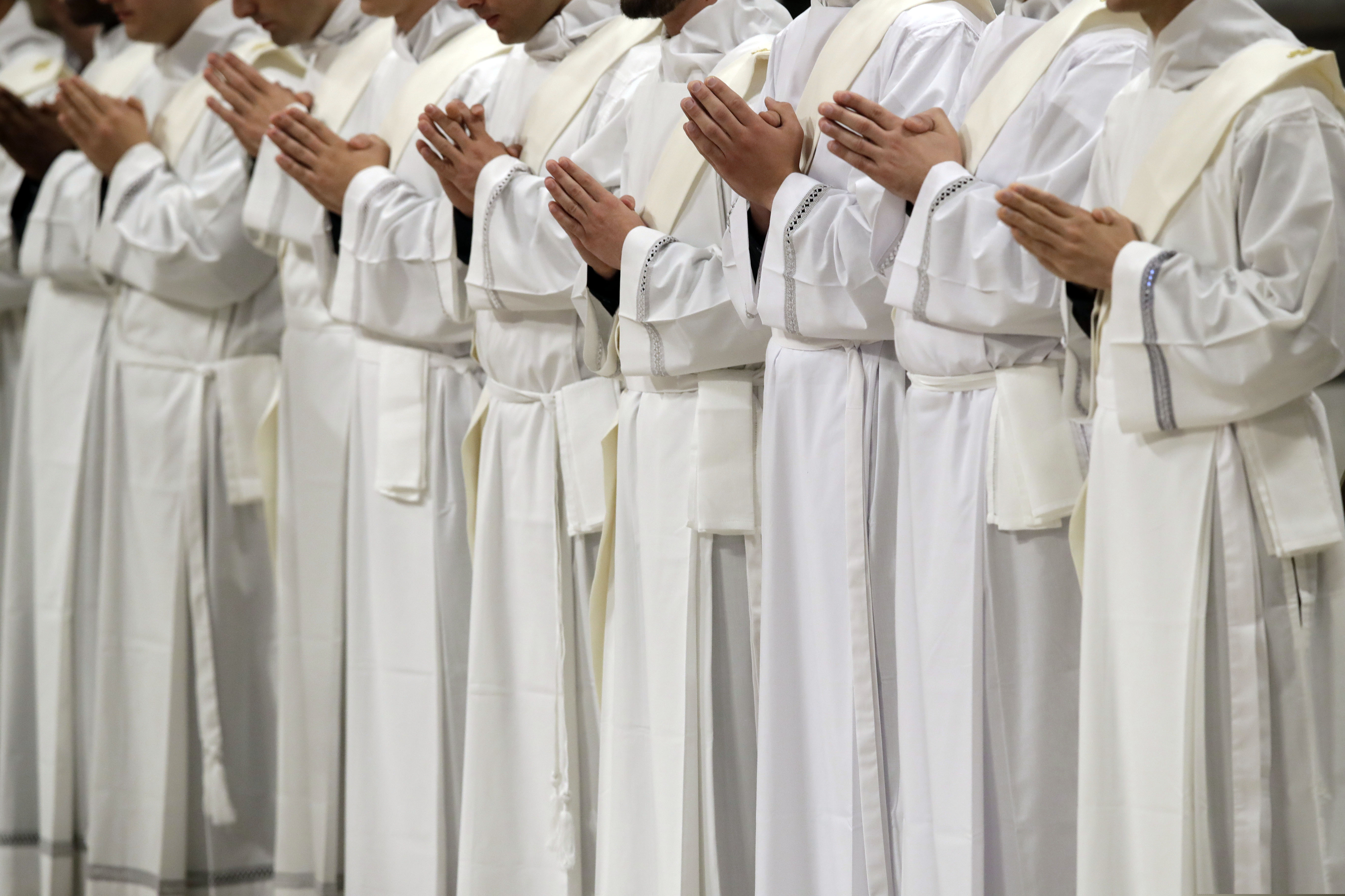 (AP Photo/Alessandra Tarantino) Newly ordained priests pray during a ceremony led by Pope Francis in St. Peter's Basilica at the Vatican, Sunday, May 12, 2019.