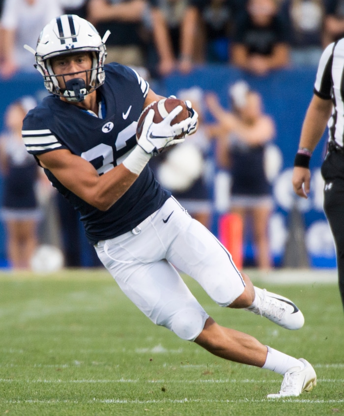 (Rick Egan  |  The Salt Lake Tribune)    Brigham Young wide receiver Dax Milne (82) runs the ball for the Cougars, in football action Brigham Young Cougars vs McNeese State Cowboys at Lavell Edwards Stadium, Saturday, Sept. 22, 2018.


