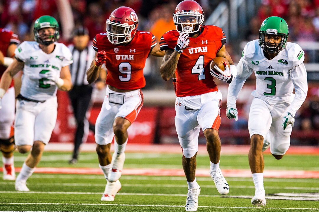 (Chris Detrick  |  The Salt Lake Tribune)  Utah Utes wide receiver Troy McCormick Jr. (4) runs past North Dakota Fighting Hawks defensive back Tyus Carter (3) and North Dakota Fighting Hawks linebacker Jade Lawrence (2) during the game at Rice-Eccles Stadium Thursday, August 31, 2017. Utah Utes defeated North Dakota Fighting Hawks 37-16.