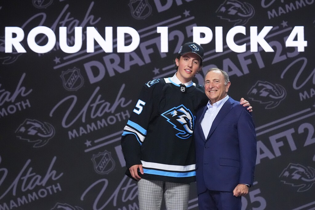 (Damian Dovarganes | AP) Caleb Desnoyers, left, stands with NHL commissioner Gary Bettman after being drafted by the Utah Mammoth during the NHL hockey draft Friday, June 27, 2025, in Los Angeles.