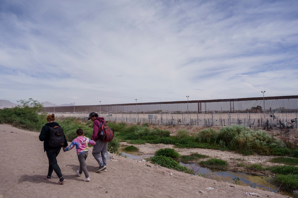 (Paul Ratje | The New York Times) Migrants from Venezuela walk along the Rio Grande looking for a place to cross the border into the U.S. in Ciudad Juarez, Mexico, Tuesday, June 4, 2024. President Biden issued an executive order on Tuesday that prevents migrants from seeking asylum at the U.S.-Mexico border when crossings surge, a dramatic election-year move to ease pressure on the immigration system and address a major concern among voters.