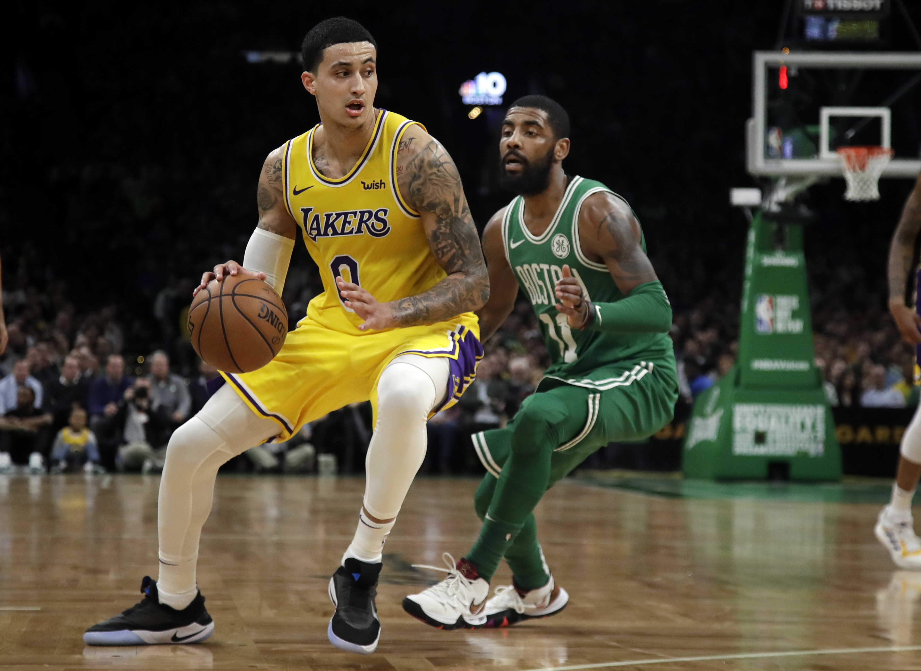 In this Feb. 7, 2019 photo, Los Angeles Lakers forward Kyle Kuzma (0) drives against Boston Celtics guard Kyrie Irving during an NBA basketball game in Boston. Kuzma is wearing Nike's latest performance basketball shoes, which from concept to reality, took about three years to put together. Or 30 years, depending on how you count. The Nike Adapt BB _ a self-lacing smart shoe that can be controlled by a smartphone _ gets released to the public on Sunday, Feb. 17, 2019, a date that just happens to coincide with the NBA All-Star Game in Charlotte. It has a motor embedded within the shoe, and a hefty $350 price tag. It has a motor embedded within the shoe, and a hefty $350 price tag. (AP Photo/Elise Amendola)