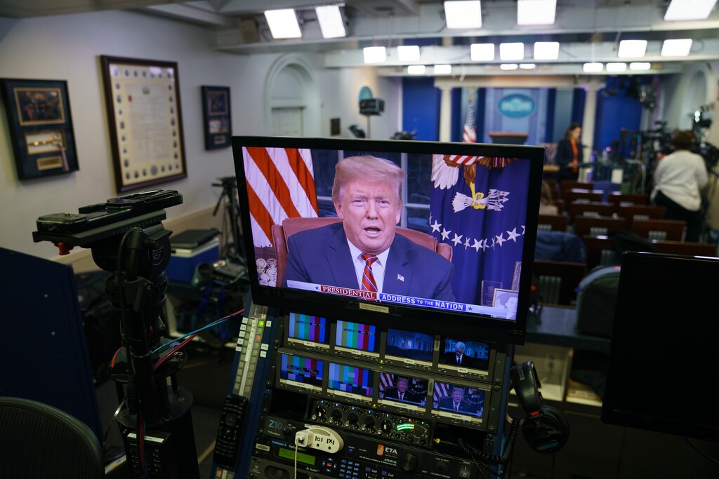 President Donald Trump is seen on monitors in the briefing room of the White House in Washington, as he gives a prime-time address in the Oval Office, Tuesday, Jan. 8, 2019. (AP Photo/Carolyn Kaster)