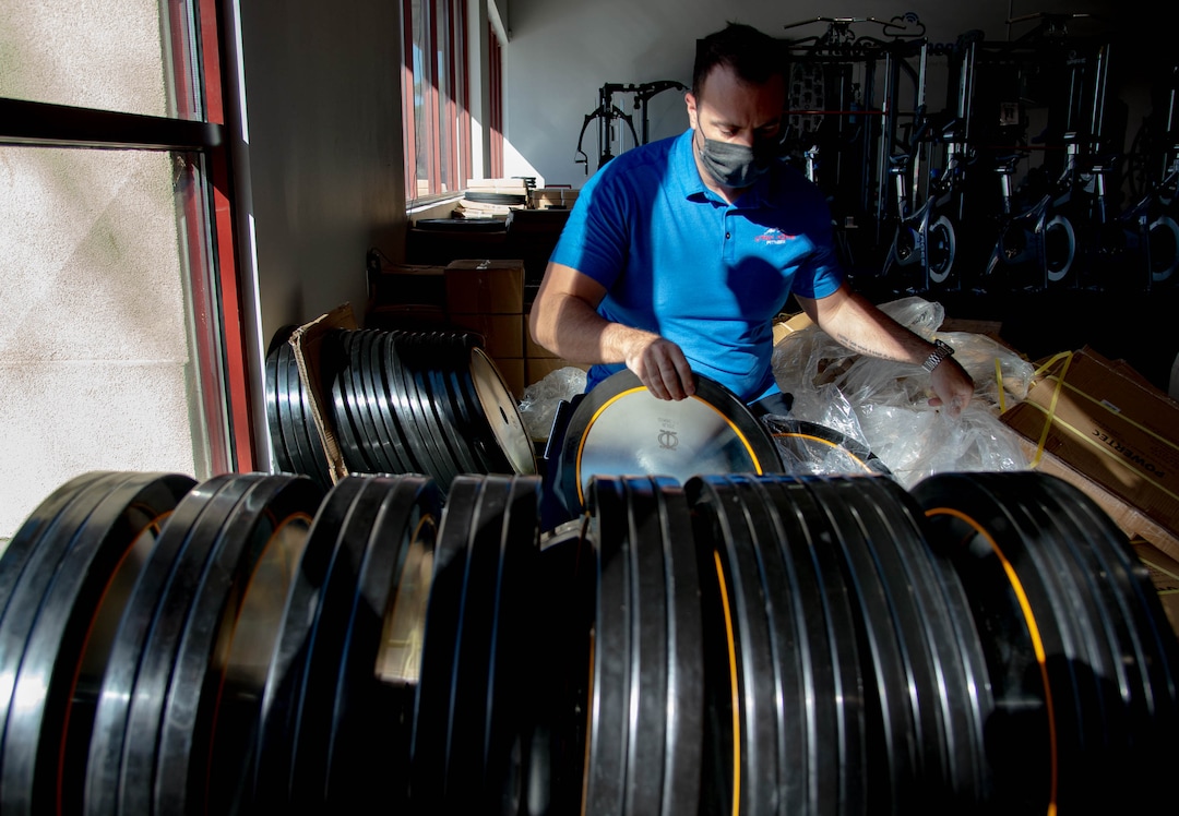 (Francisco Kjolseth  |  The Salt Lake Tribune) Clint Eisinger, operations manager at Utah Home Fitness in Sandy, takes advantage of a slow moment to catch up on restocking inventory on Wednesday, Oct. 22, 2020. Home fitness equipment sales boomed in March and April when gyms closed because of the coronavirus. Everything from inexpensive dumbbells to premium treadmills and ellipticals were wiped out of stores and warehouses. Record sales continue throughout the summer — normally the slow time for the industry, and store owners expect sales to remain high during the holidays.
