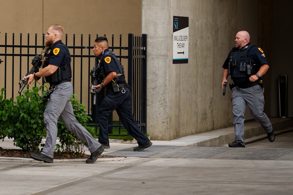 (Trent Nelson | The Salt Lake Tribune) A man lays injured on the street as police respond to a reported shooting during a protest march in Salt Lake City, Saturday, June 14, 2025.