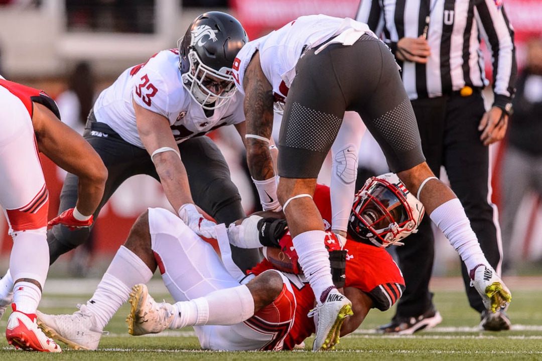 (Trent Nelson | The Salt Lake Tribune)  Utah Utes running back Zack Moss (2) is brought down as the University of Utah hosts Washington State, NCAA football in Salt Lake City, Saturday November 11, 2017.