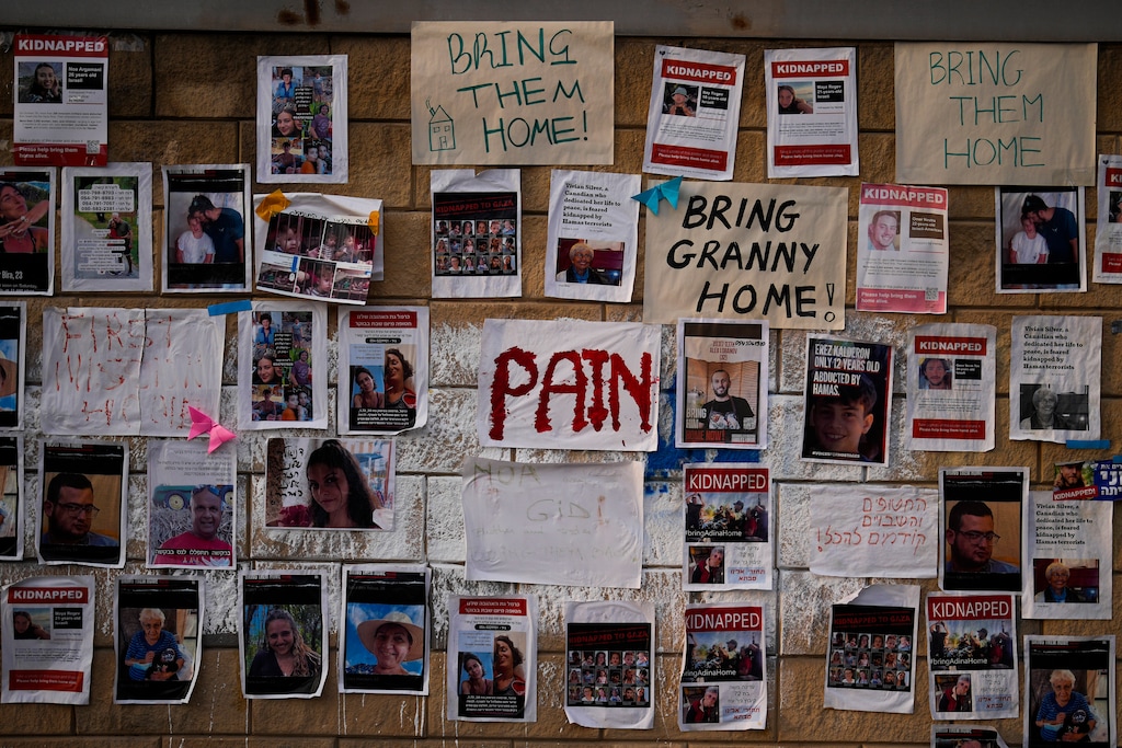 (Francisco Seco | AP) Photographs of people who were abducted during last week's unprecedented Hamas attack on Israel are fixed to a wall in Tel Aviv, Israel, Friday, Oct. 27, 2023.