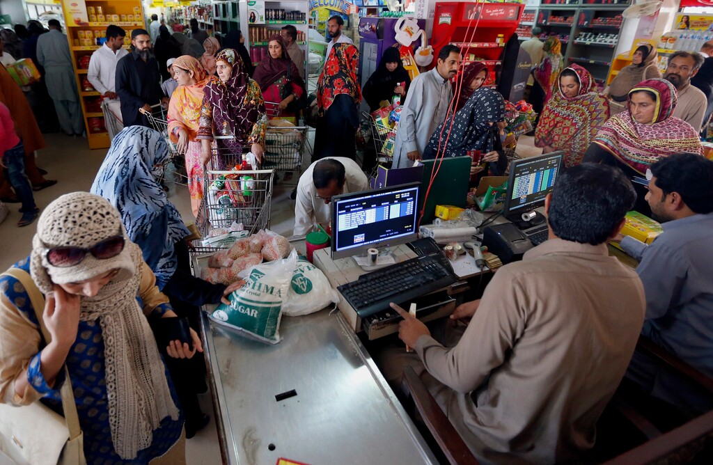 (AP Photo/Anjum Naveed) People wait in line to pay for specially priced foodstuff for the upcoming Muslim month of Ramadan, at a government-run supermarket in Islamabad, Pakistan, Wednesday, May 16, 2018. Muslims across the world will be observing the holy fasting month of Ramadan, when they refrain from eating, drinking and smoking from dawn to dusk.