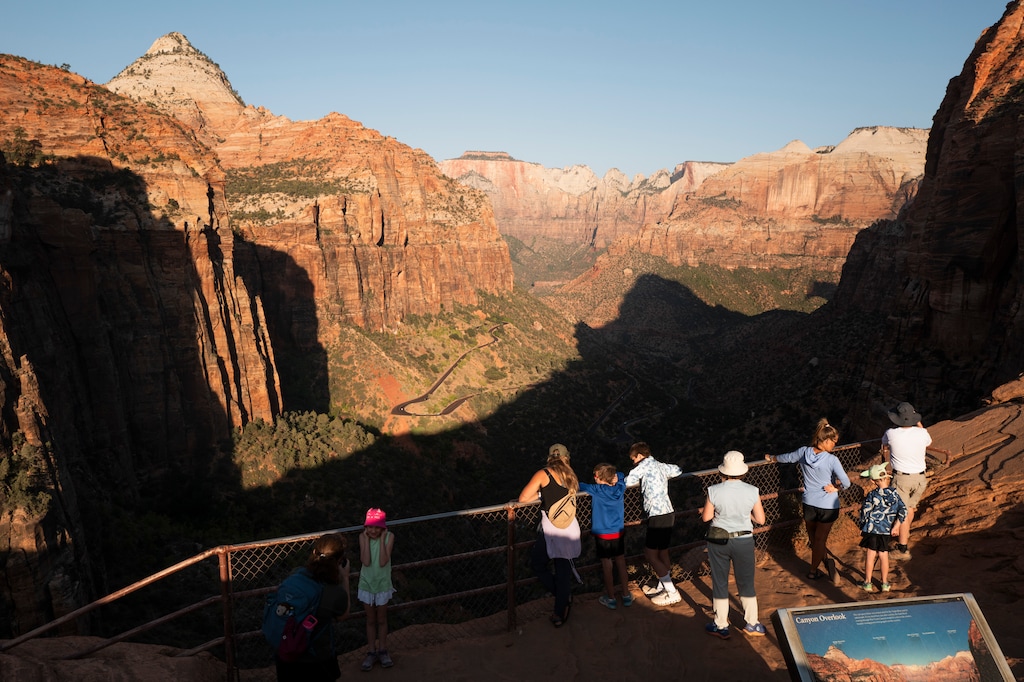 (Erin Schaff | The New York Times) Visitors at Zion National Park in Utah, Aug. 15, 2025. Amid deep staffing cuts, more than 90 parks have reported problems like lost revenue and cuts to emergency services. One expert called this "a dangerous path."