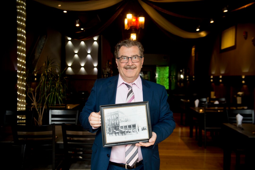 (Jeremy Harmon  |  The Salt Lake Tribune) Raffi Daghlian holds a picture of his restaurant, Cedars of Lebanon, as it looked in 1908. The restaurant is closing after 38 years. He is seen here on May 24, 2019.