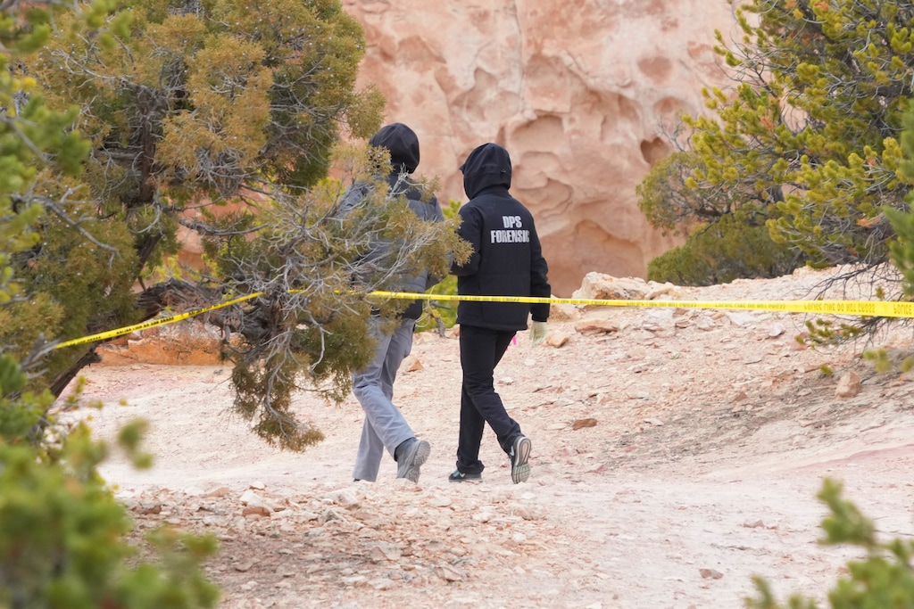 (George Frey | AP) Authorities conduct an investigation, Thursday, March 5, 2026, into the deaths of Linda Dewey and her niece Natalie Graves, who were shot a day earlier on a trail just west of Capitol Reef National Park near Teasdale.