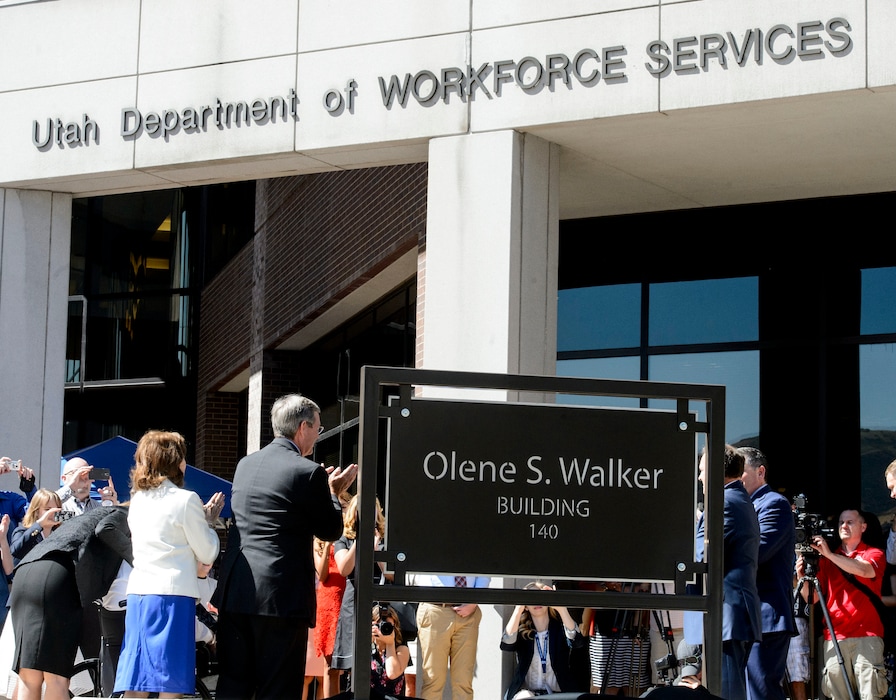 Steve Griffin | The Salt Lake Tribune
Former Gov. Mike Leavitt and Gov. Gary Herbert and family members of Olene Walker applaud during ceremony where the State renamed the DWS building, background, in honor of former Gov. Olene Walker, who 20 years ago led an effort to make Utah the first state to consolidate employment and public assistance programs. The event was held outside the DWS building in Salt Lake City Thursday June 29, 2017.