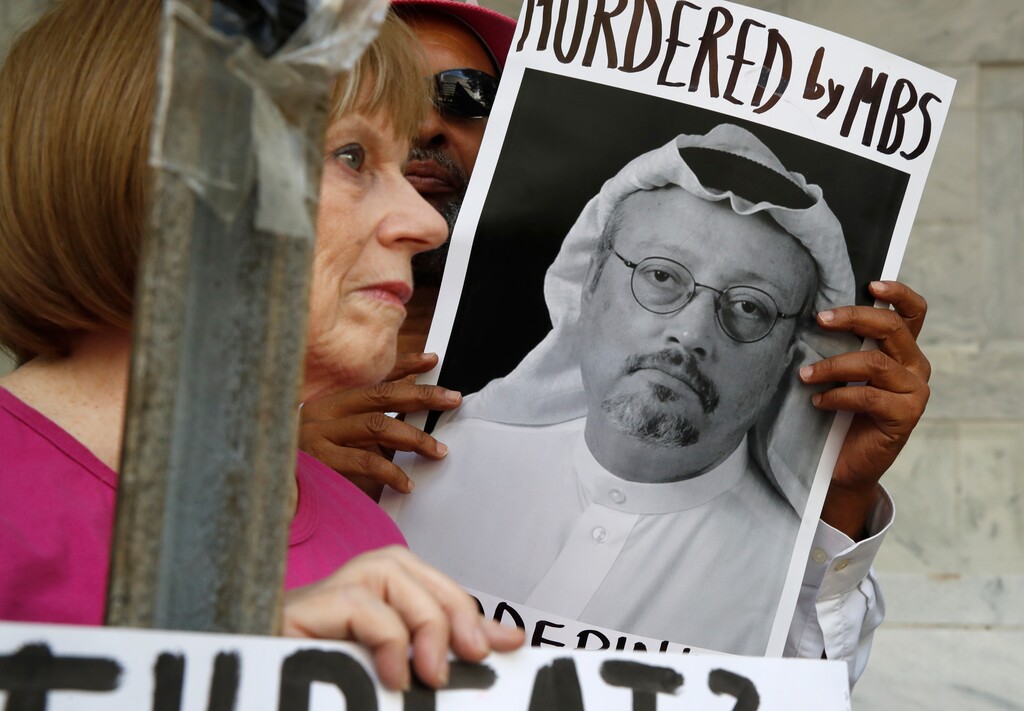 FILE - In this Oct. 10, 2018, file photo, people hold signs during a protest at the Embassy of Saudi Arabia about the disappearance of Saudi journalist Jamal Khashoggi, in Washington. Saudi Arabia’s financial clout among the Arab media has given it an influential tool as it grapples with the international outcry first over the disappearance and later the death of Saudi writer Jamal Khashoggi. From the time he vanished into the kingdom’s consulate in Istanbul, Riyadh’s allied newspapers and TV stations across the region echoed the Saudi denial of any knowledge of his fate or weaved alternative scenarios of an alleged plot by rivals Qatar and Turkey to destabilize the kingdom. (AP Photo/Jacquelyn Martin, File )