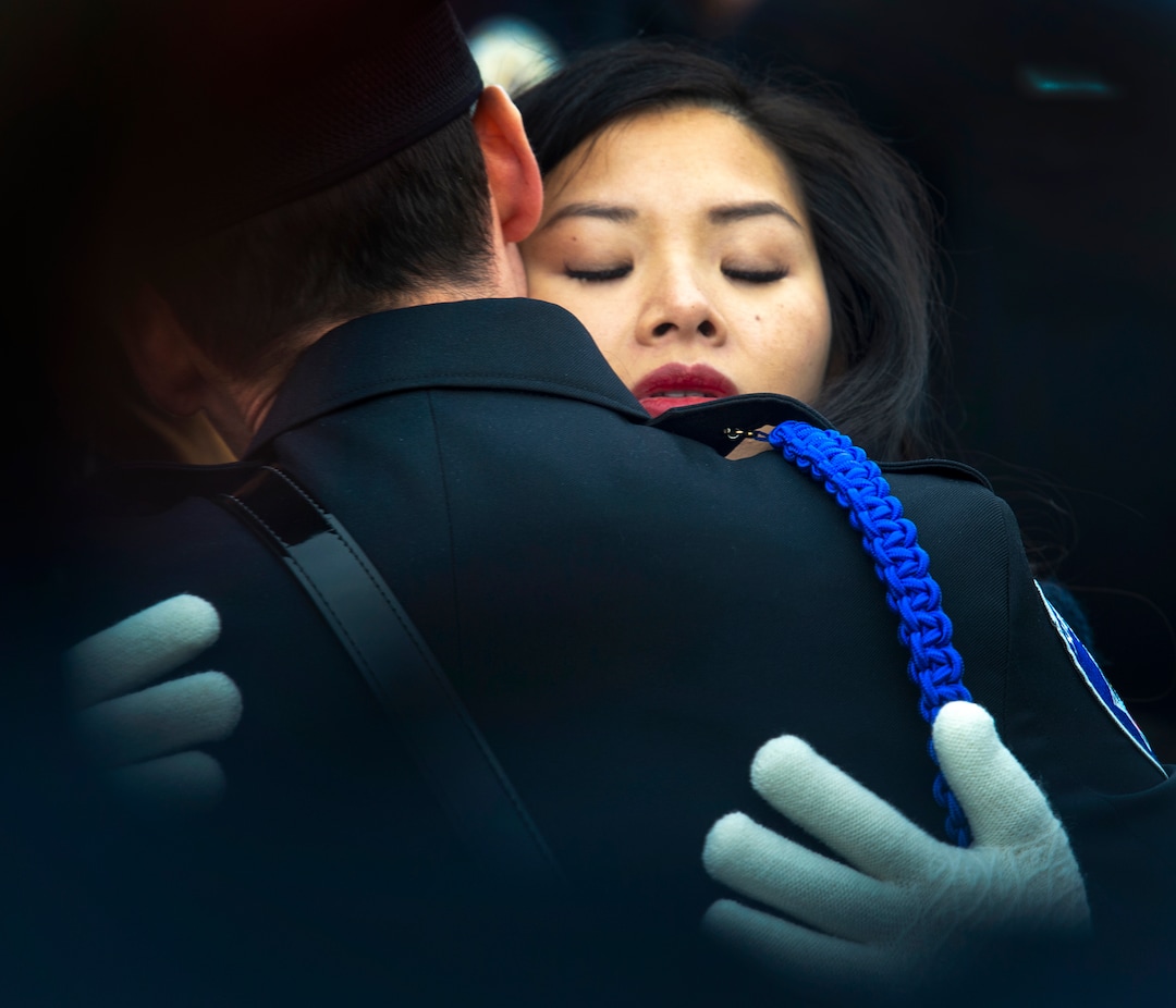 (Rick Egan  |  The Salt Lake Tribune)     Elizabeth Romrell, wife of South Salt Lake police officer, David Romrell gets a hug, before the funeral at the Maverik Center, in West Valley City, Wednesday, Dec. 5, 2018.