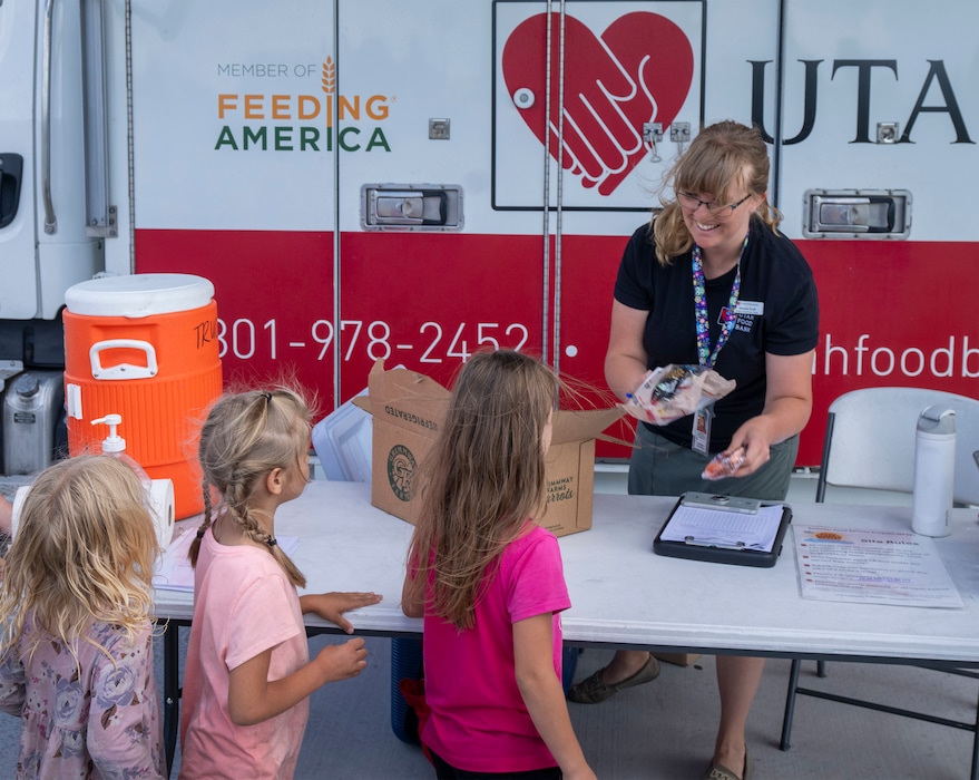 (Rick Egan | The Salt Lake Tribune) Jessica Scott, mobile school pantry coordinator for the Utah Food Bank, hands out sack lunches at Magna Regional Park on Friday, June 21, 2024.