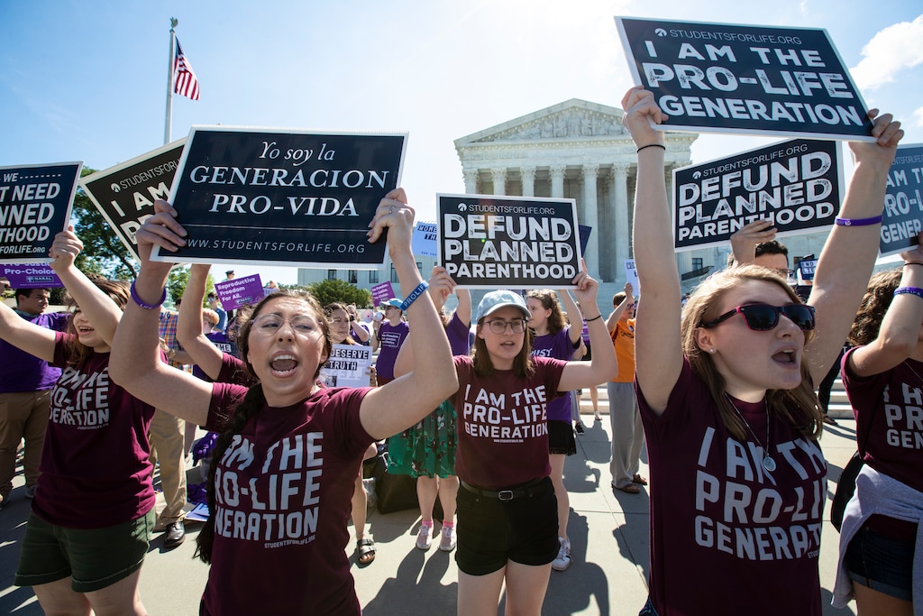 FILE - In this June 25, 2018 file photo, pro-life and anti-abortion advocates demonstrate in front of the Supreme Court. On Wednesday, Nov. 28, 2018, representatives of several national anti-abortion groups met with administration staffers at the White House to discuss how President Donald Trump _ who has supported their agenda _ could continue to be helpful in the changed political circumstances.  (AP Photo/J. Scott Applewhite, File)