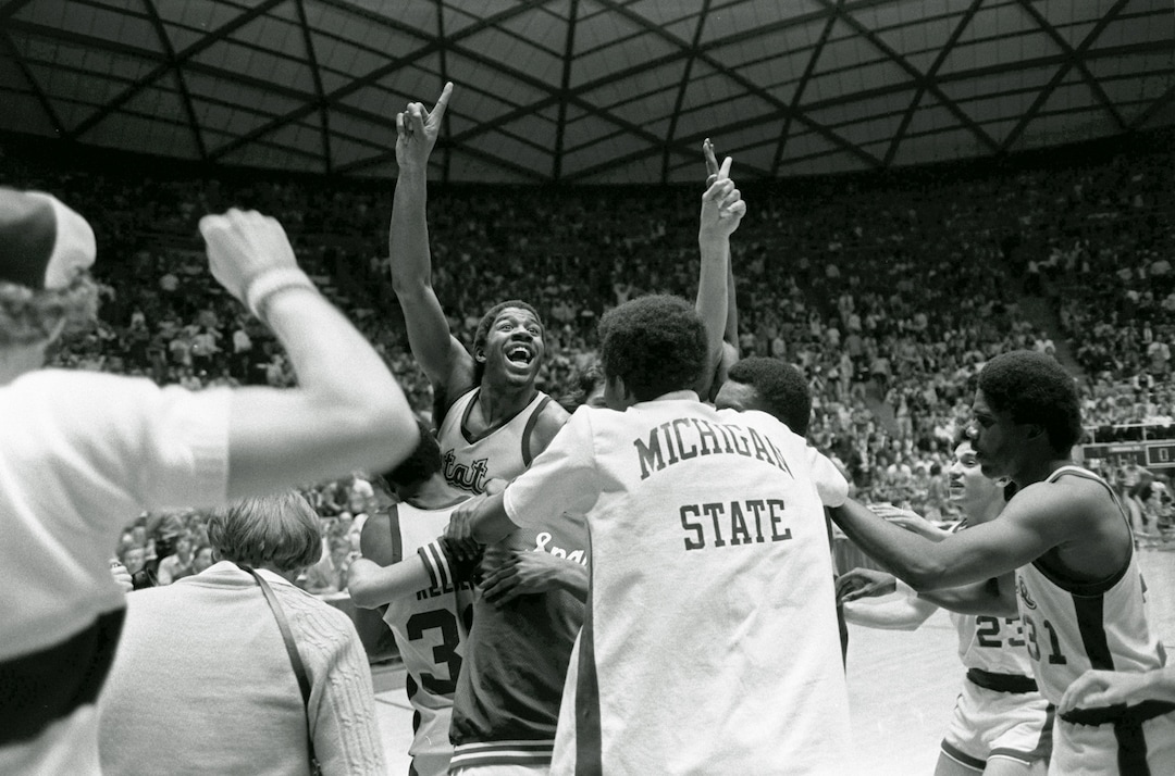 (AP Photo) Michigan State's Earvin (Magic) Johnson raises his finger to indicate the Spartans are number one after defeating Larry Bird's Indiana State team 75-64 to win the NCAA Championship in Salt Lake City, March 26, 1979. 