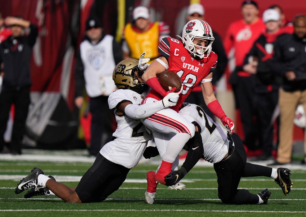 (Francisco Kjolseth | The Salt Lake Tribune) Utah Utes wide receiver Britain Covey (18) tries to push past the Buffaloes defense as the University of Utah hosts the Colorado Buffaloes in Pac-12 football, Friday, Nov. 26, 2021 at Rice-Eccles Stadium.