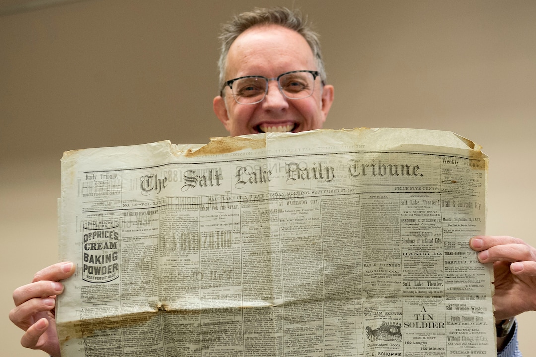 (Jeremy Harmon  |  The Salt Lake Tribune) Archivist Alan Barnett shows a copy of The Salt Lake Daily Tribune that was found inside a time capsule that was buried in the corner stone of Ogden Academy on September 27, 1887. Items from the time capsule were displayed at the Utah State Archives on Wednesday, Oct. 16, 2019.